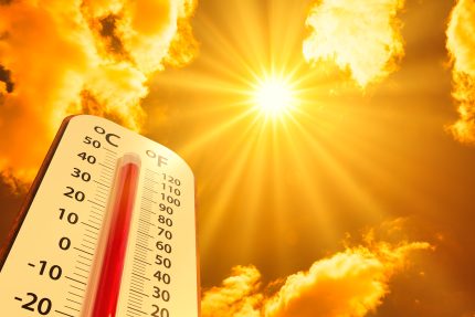 hot temperature,Thermometer on yellow sky with sun shining in summer